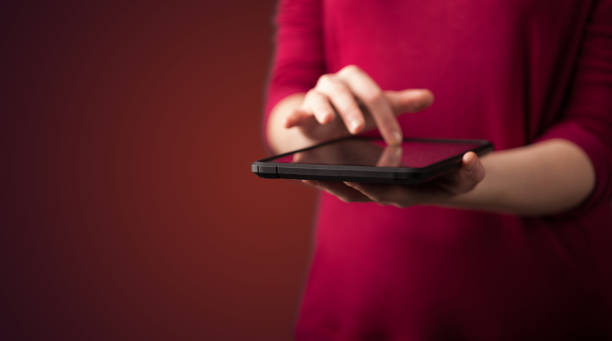 istock Close up of hand holding digital touchpad tablet device 890858766