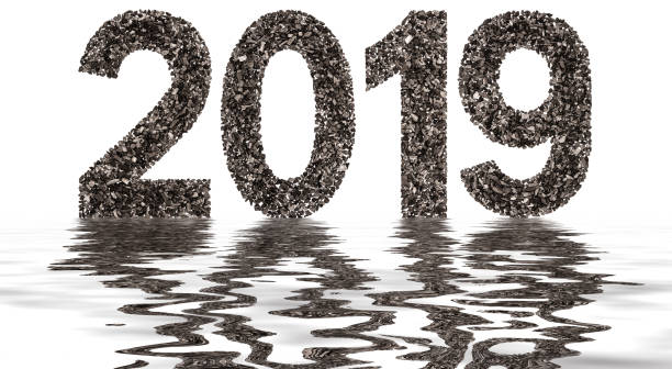 istock Numeral 2019 from black a natural charcoal, isolated on white background, reflection in water 890862172