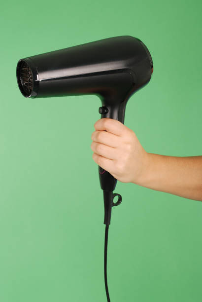 istock Hand holding hair dryer 890867918