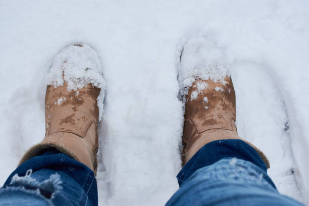 istock Brown boots in the snow, self-recording 890868108