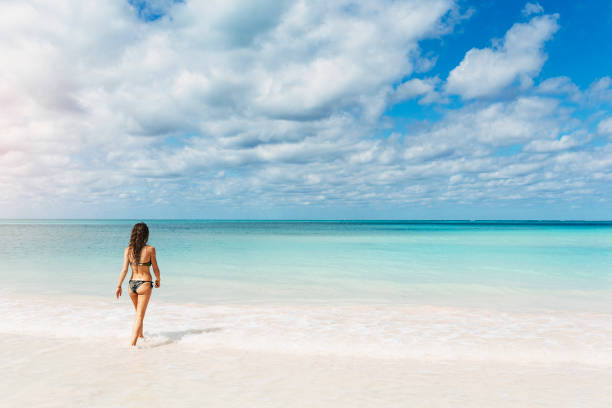 istock Young woman relax on the beach. 890868238