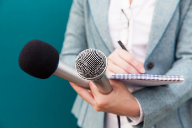 Female reporter taking notes at press conference