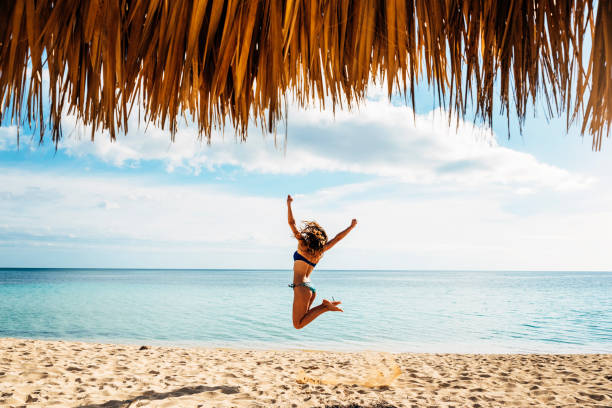 若い女性は、ビーチでリラックスします。 - swimwear caribbean sea beach water ストックフォトと画像