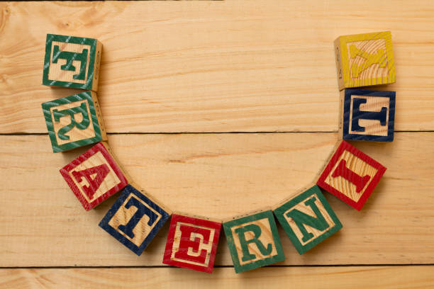 istock fraternity wood cube words on wooden table 890882870