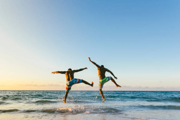 Two cuban friends having fun in the beach. Friendship concept.