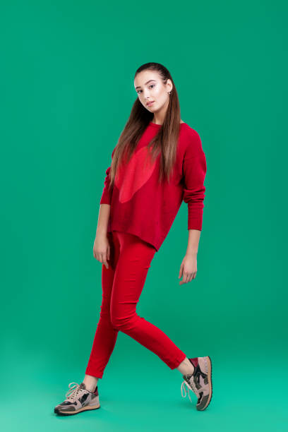 istock woman in red sweater on green background 890883740