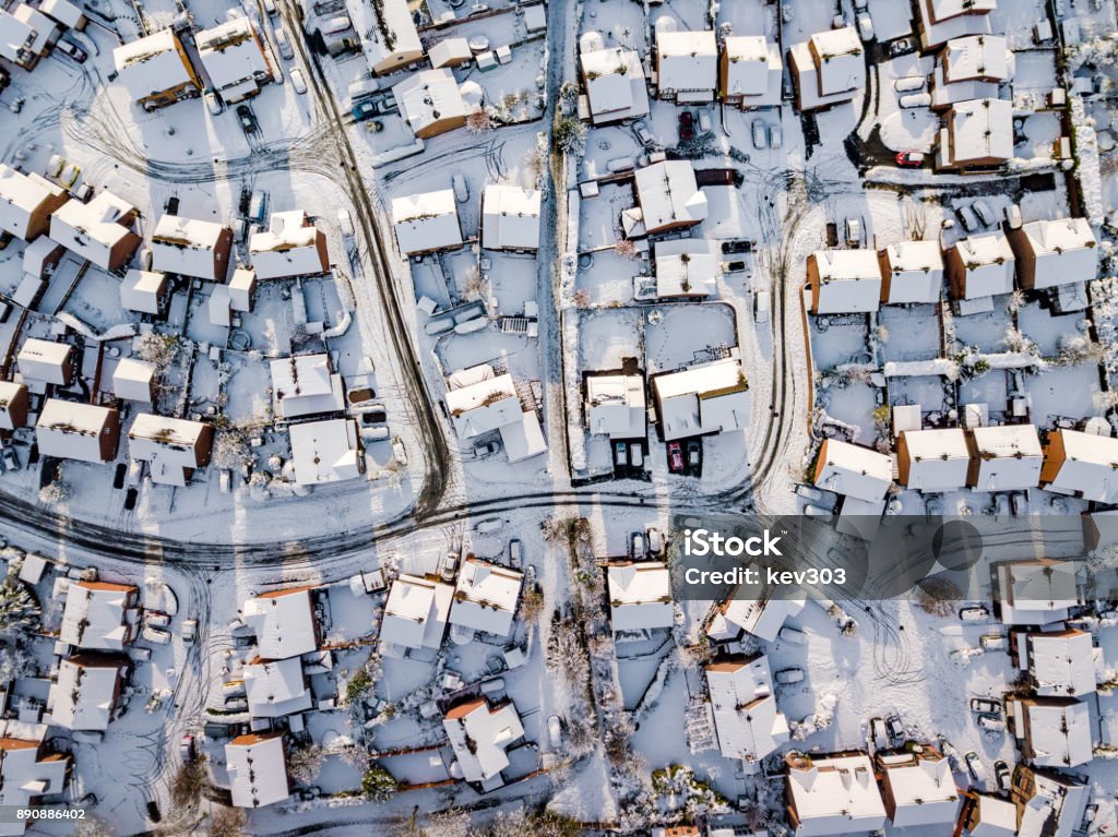 Aerial view of snowed in traditional housing suburbs in England. Snow, ice and adverse weather conditions bring things to a stand still. Snow Stock Photo