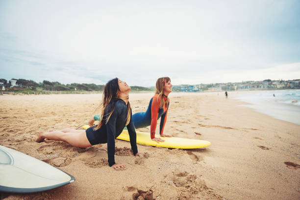 istock Two young women warming up for surfing in Australia 890886932