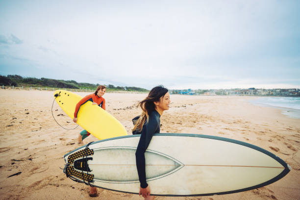 istock Beautiful gritty women go surfing in Australia 890886998