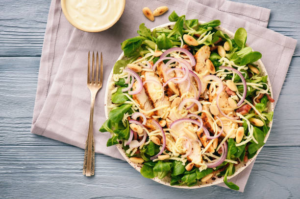 istock Salad with grilled chicken meat, bacon, almond and garlic dressing. 890887232