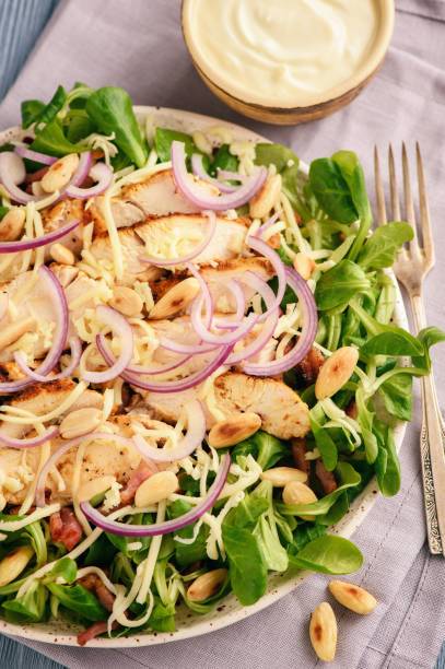 istock Salad with grilled chicken meat, bacon, almond and garlic dressing. 890887264