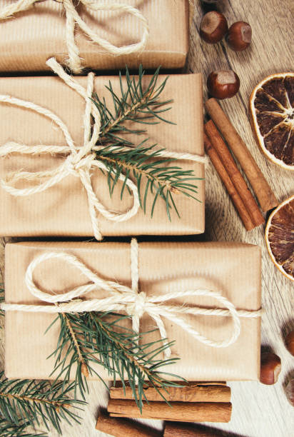 istock Christmas gifts in rustic boxes on wooden background. 890904326