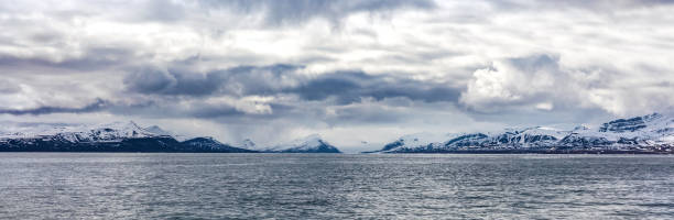 istock Panorama of clouds over snowy mountains in the arctic 890908274