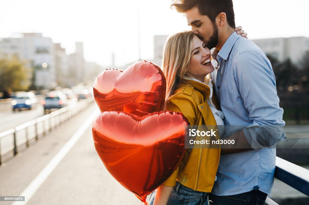 Romantic young couple in love, hugging on the street Romantic young couple in love, hugging on the street on valentine day Valentine's Day - Holiday Stock Photo