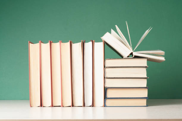 istock Open book, hardback books on wooden table. Education background. Back to school. Copy space for text. 890916192