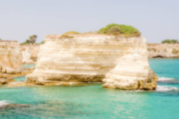 Defocused background with scenic rocky cliffs in Salento, Italy. Intentionally blurred post production for bokeh effect