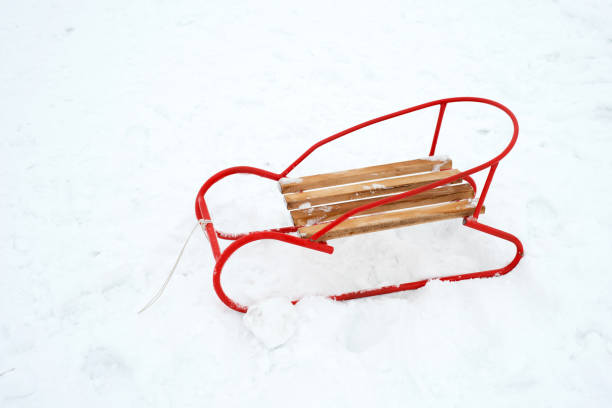 istock wooden sled on the snow - copy space 890922982