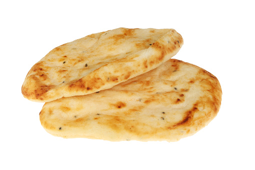 Two flamebaked naan breads isolated against white