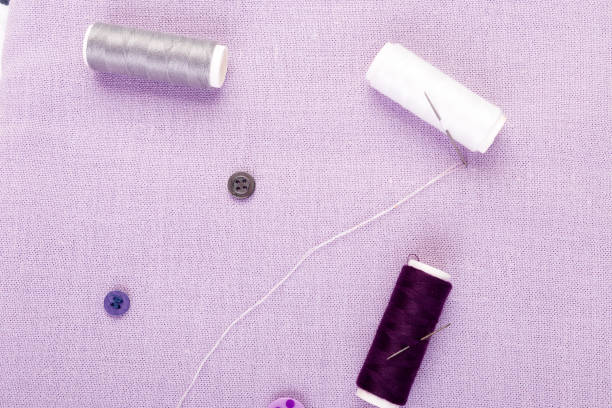istock Items for sewing clothes. Sewing buttons, spools of thread and cloth. Top view. 890924574