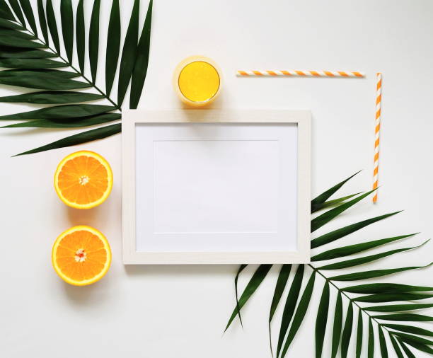 istock Palm branches, photo frame and orange juice 890926748