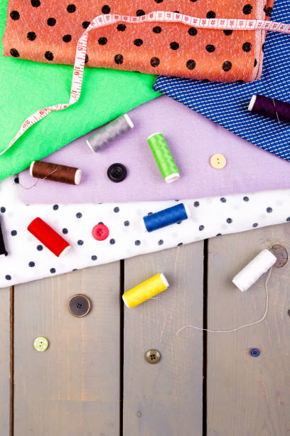 istock Items for sewing clothes. Sewing buttons, spools of thread and cloth. Top view. 890931908