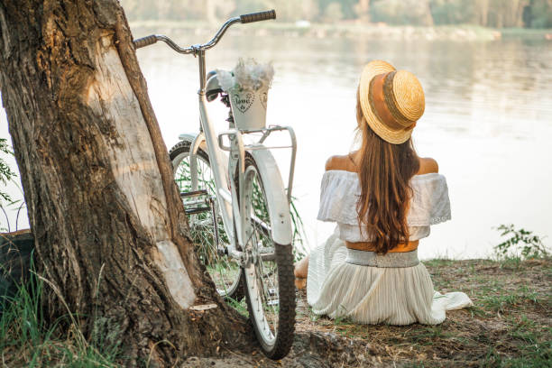 istock A young girl next to an old tree on the beach 890936668