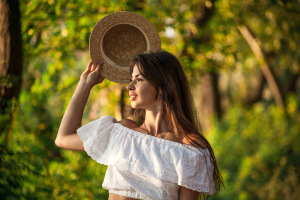 istock The girl is covered with a hat from the sun 890940602