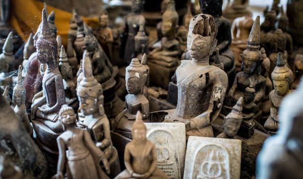 istock Antique meditating Buddha statues made as Buddhist ritual offering found in a cave 890940778