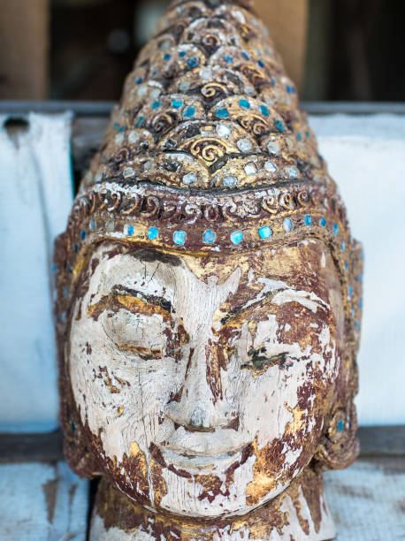 istock Wooden buddha head antique statue 890940782