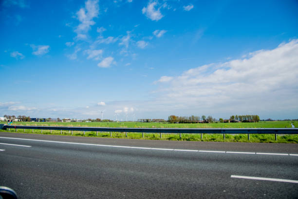 istock on a european road with green grass and blue sky 890946098