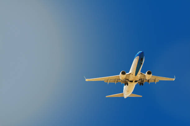 istock Airliner flying with sun in the background 890952514