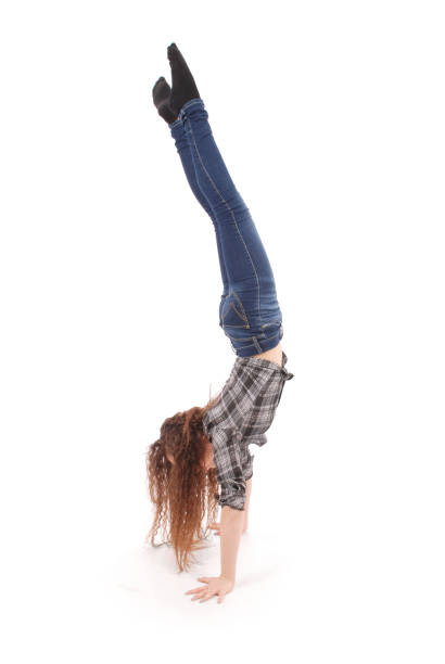 istock Girl in jeans doing acrobatic stunt 890964080