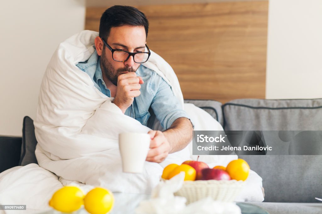 Suffering from cold Young man coughing and suffering from cold Fever Stock Photo