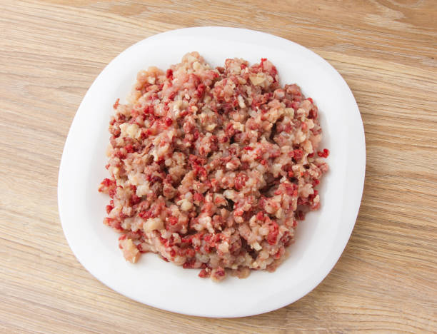 Raw ground meat on a white plate.