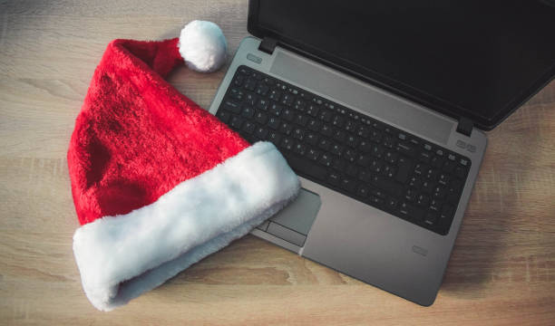 istock Laptop with blank screen and Santa Claus hat 890996020
