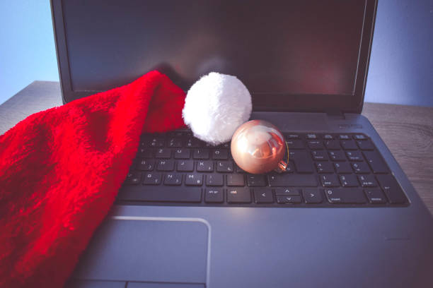 istock Santa Hat with Laptop on wooden table 890996848