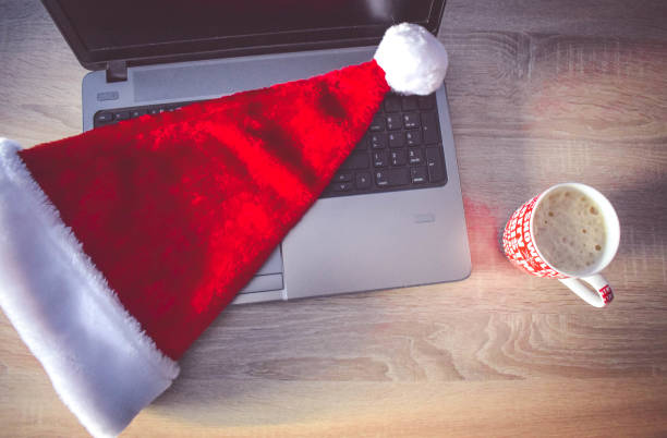 istock Christmas work place with laptop and Santa hat 890996926