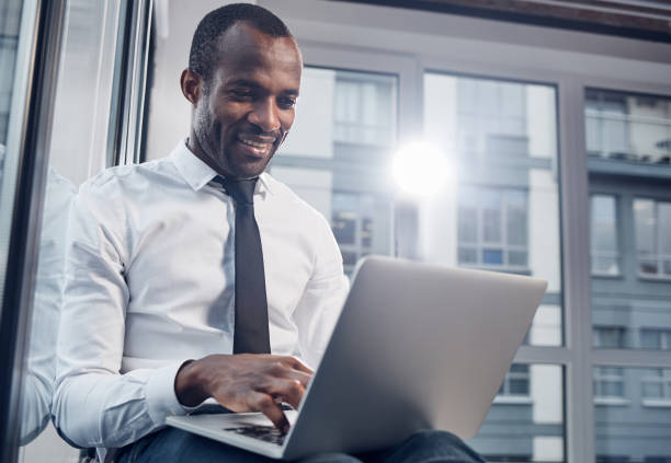 istock Joyful cute man is looking at screen of his gadget 891009702