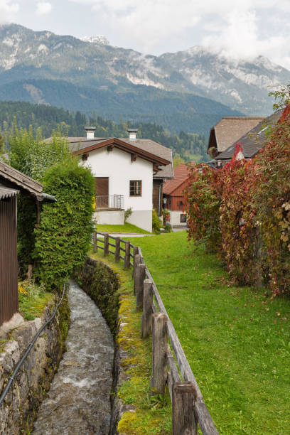 istock Mountain stream flows through Alpine village Haus in Austria. 891009950