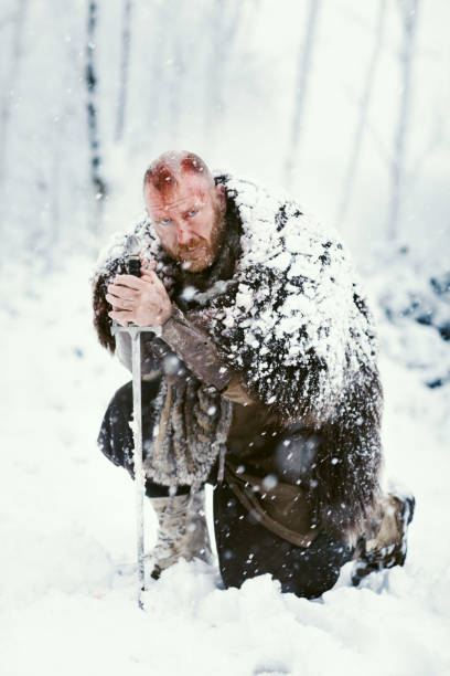 istock Weapon wielding bloody viking warrior outdoors in a winter blizzard 891010922