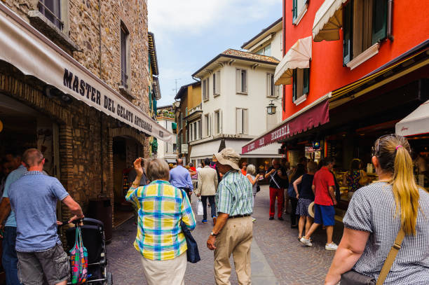 SIRMIONE, ITALY - JUNE 26, 2014: Shopping street in the Sirmione town, Italy. Sirmione became popular touristic destination on the Lake garda, the largest lake in Italy