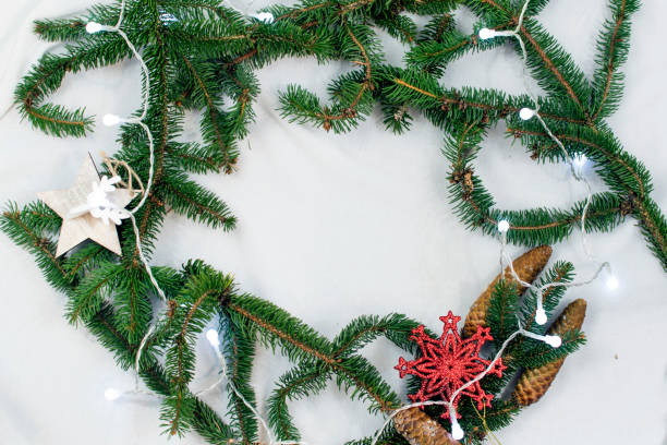 istock Christmas background with spruce springs and holiday decorations. Christmas tree lights. Place for text 891027062
