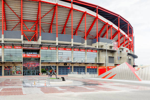 Kids in soccer sportswear on stadium with ball.