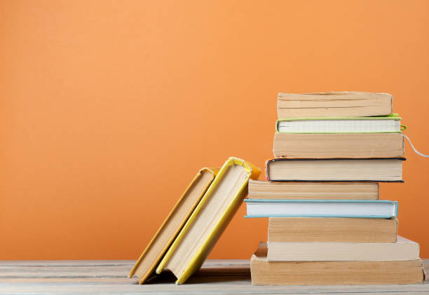 Stack of books on the wooden table. Education background.Back to school. Copy space for text. stock photo
