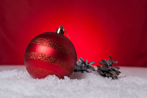 istock Christmas balls and cones on a red background 891048176