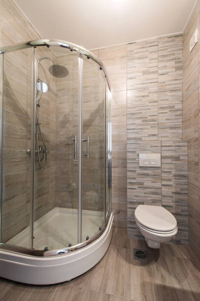 istock Brown bathroom including shower and toilet 891049394