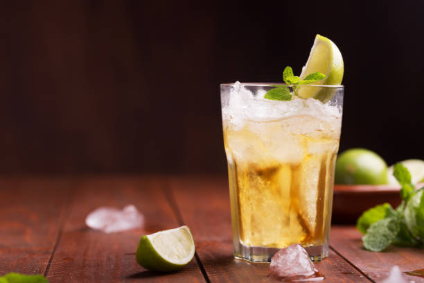 Fresh cocktail prepared with ginger beer, lime and ice stock photo