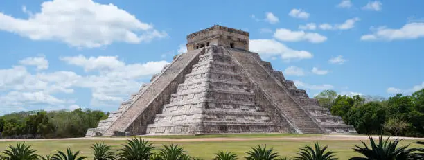 Chichen Itza has multiple ancient Mayan ruins, including the El Castillo aka Kukulkan Pyramid. It's one of the most popular travel destination on the Yucatan peninsula in Mexico. All people and vendors have been removed.