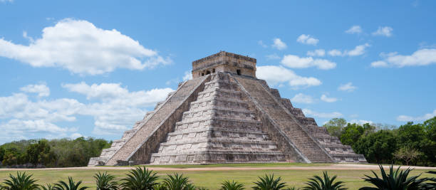 Best Chichen Itza pyramid (aka Kukulkan or El Castillo) pyramid ruins - Landscape Panorama Chichen Itza has multiple ancient Mayan ruins, including the Kukulkan / El Castillo Pyramid. It's one of the most popular travel destination on the Yucatan peninsula in Mexico. All people and vendors have been removed. chichen itza photos stock pictures, royalty-free photos & images