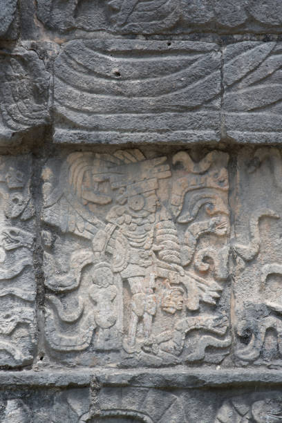 istock Mayan warrior with severed head stone carving at the Mayan ruins at Chichen Itza 891054630